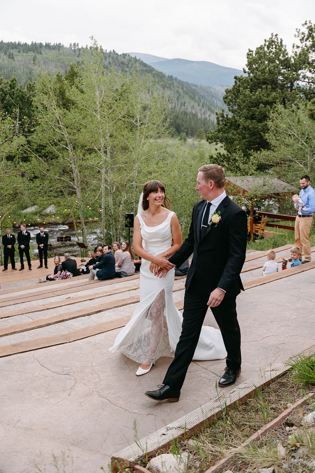 Jason and Amy kissing on the rocks framed by aspen trees